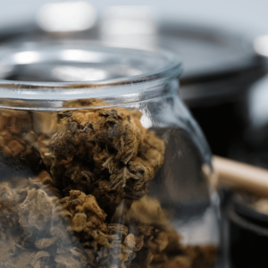 brown and green cannabis flower in glass jar