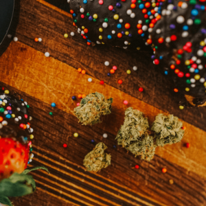 cannabis flower surrounded by sprinkle doughnuts