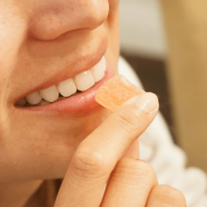 girl smiling with CBd gummies