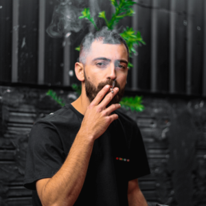 man in black shirt smoking a joint