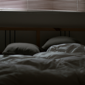 white and gray bed set in a dark room