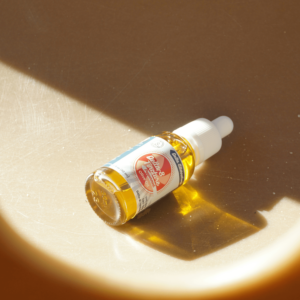 gold tincture bottle with white label