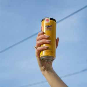 hand holding yellow can cannabis drink