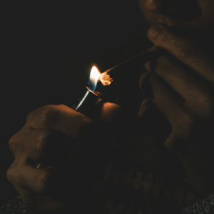 person lighting a joint