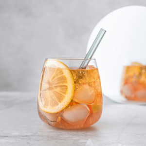 orange cocktail with metal straw