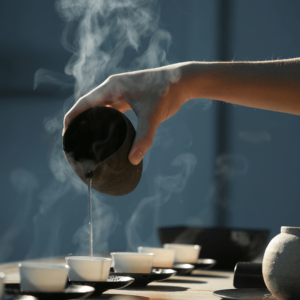 person pouring tea