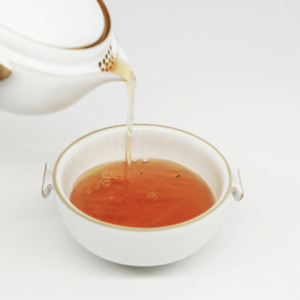 white tea pot pouring tea