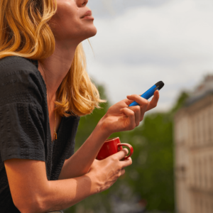 a girl smoking a blue vape