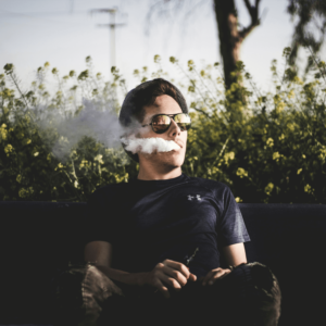 man in black shirt smoking 