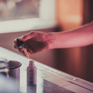 person dispensing cannabis oil