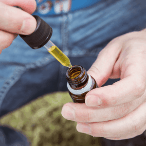hands holding CBD tincture bottle