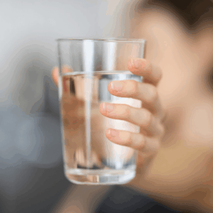 person holding a glass of water