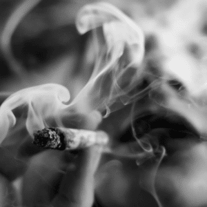 greyscale image of a girl smoking a joint