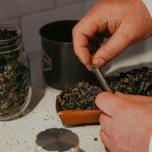 person stuffing a joint