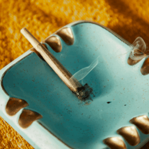 joint burning on blue ashtray