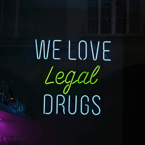 neon sign that says we love legal drugs