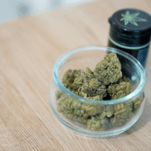 buds in bowl next to black jar