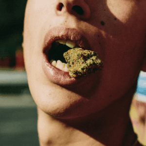 person with cannabis bud in mouth