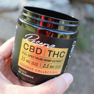 person holding cannabis jar