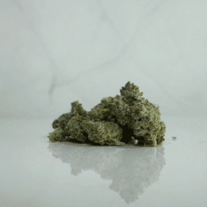 green flower against marble background