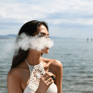 girl in white crochet top vaping