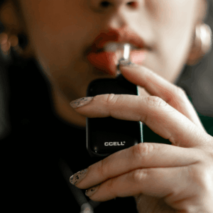 person holding black vape