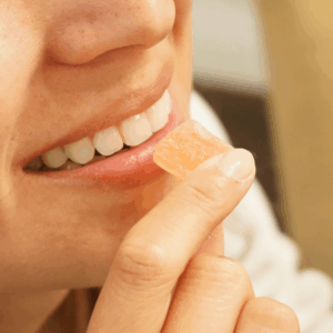 girl smiling and holding gummy