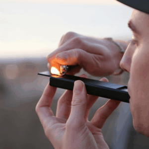 man smoking black bowl