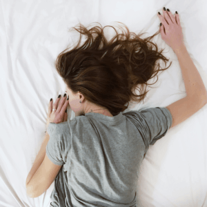 girl with dark hair and gray shirt sleeping