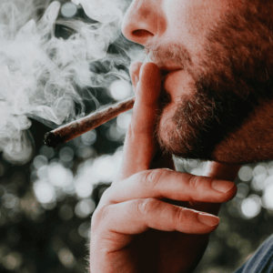 man with beard smoking a pre-roll