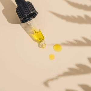 gold oil in dropper on table