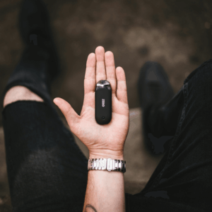 black vape pod system on palm