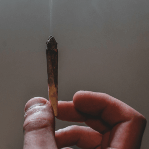 hand holding burning joint