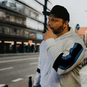 man in hoodie smoking joint