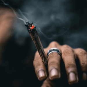 hand holding burning joint