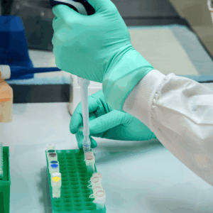 gloved hand holding syringe