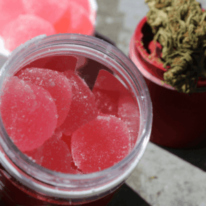 pink gummies in jar with nugs in background