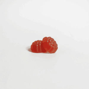 two red gummies against white background